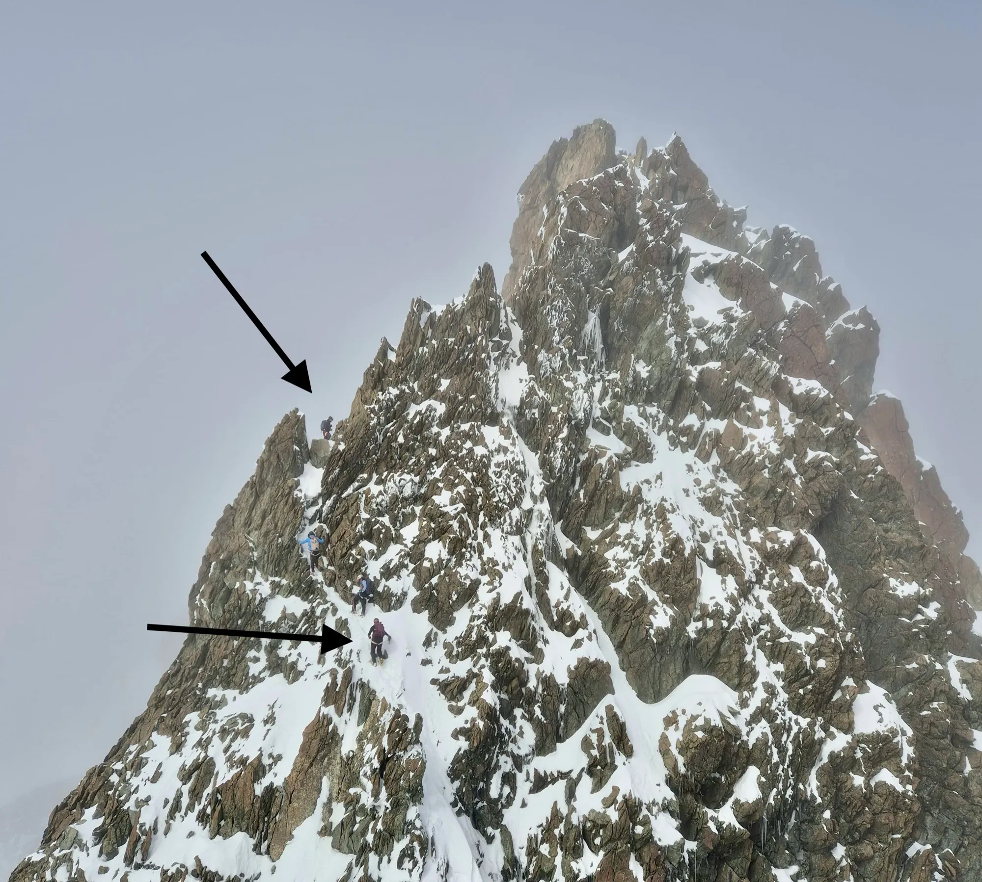 The tower on the Breithorn half traverse, the crux of the whole line. Find the arrows: a German, an Italian, and an Australian ahead of us, because the urge to defy death needs no translation.